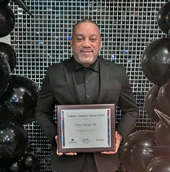 Felix Turner alumnus Felix Turner holding award