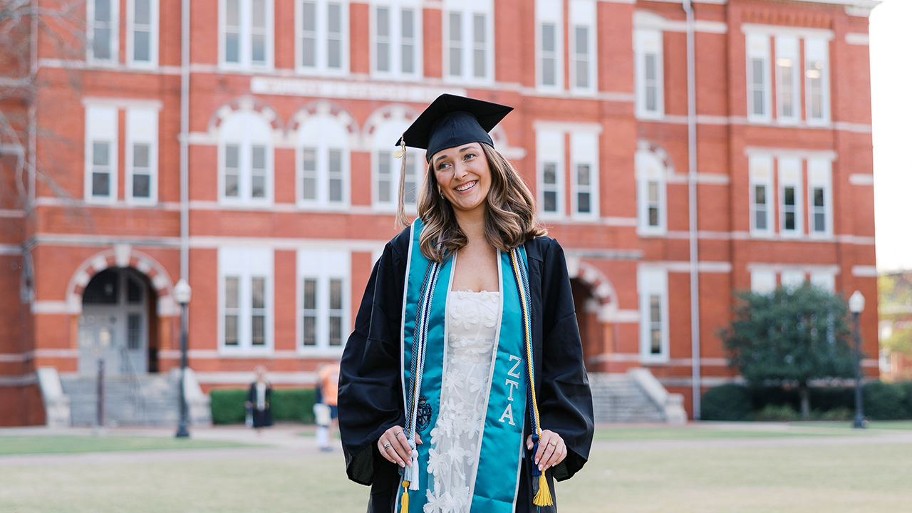 Reese Tobin mgmt grad marshal Woman grad in cap and gown