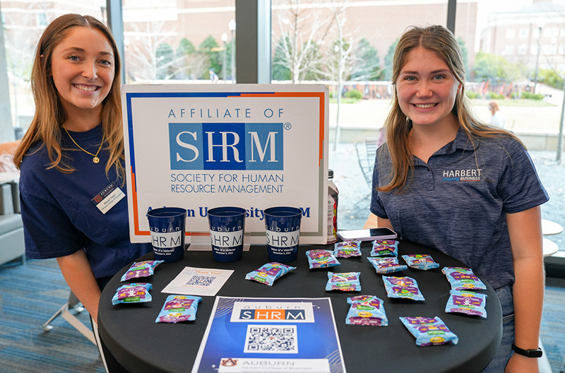 Reese Tobin with SHRM VP Two students standing at display table