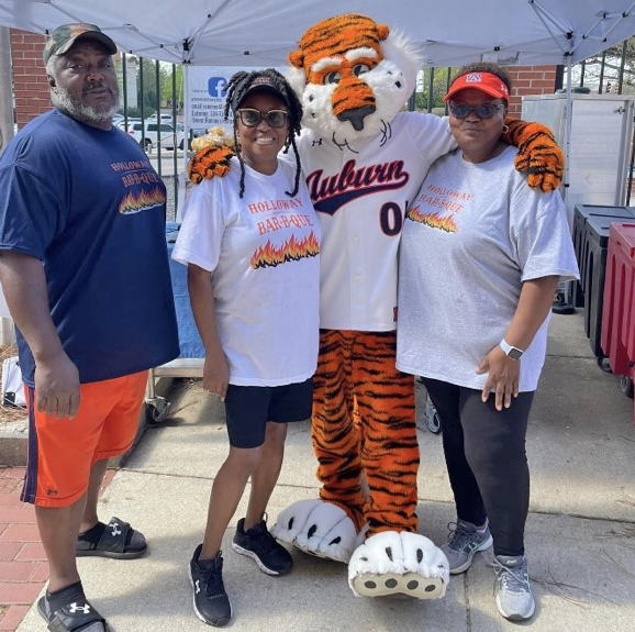 Holloway and family 3 people and Aubie at baseball park