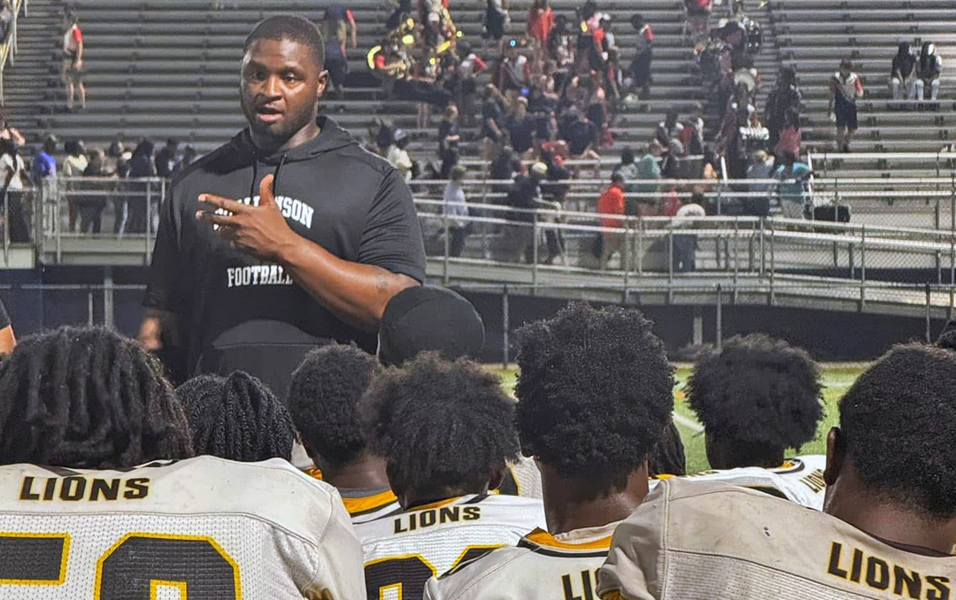 Coach talking to football team