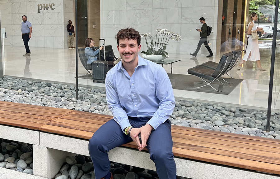 Man sitting on bench outside office building