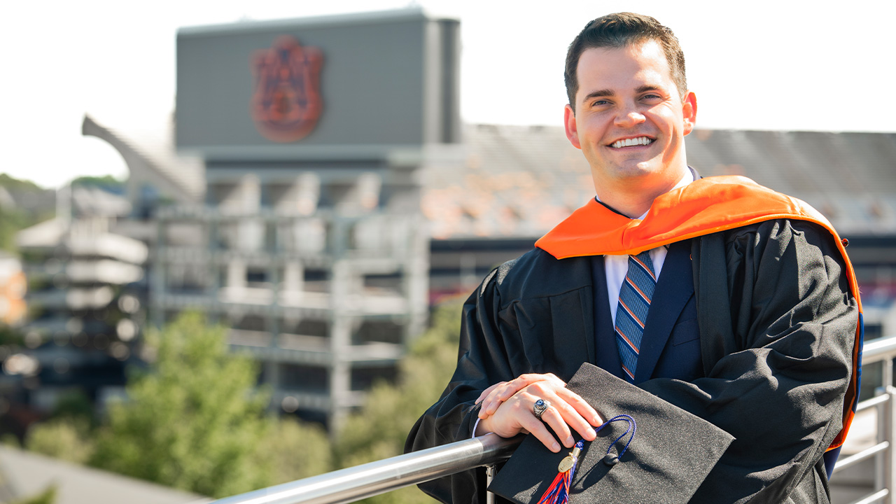 Man standing in cap and gown