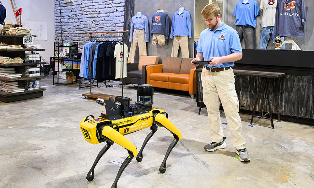 Man operating robot in lab