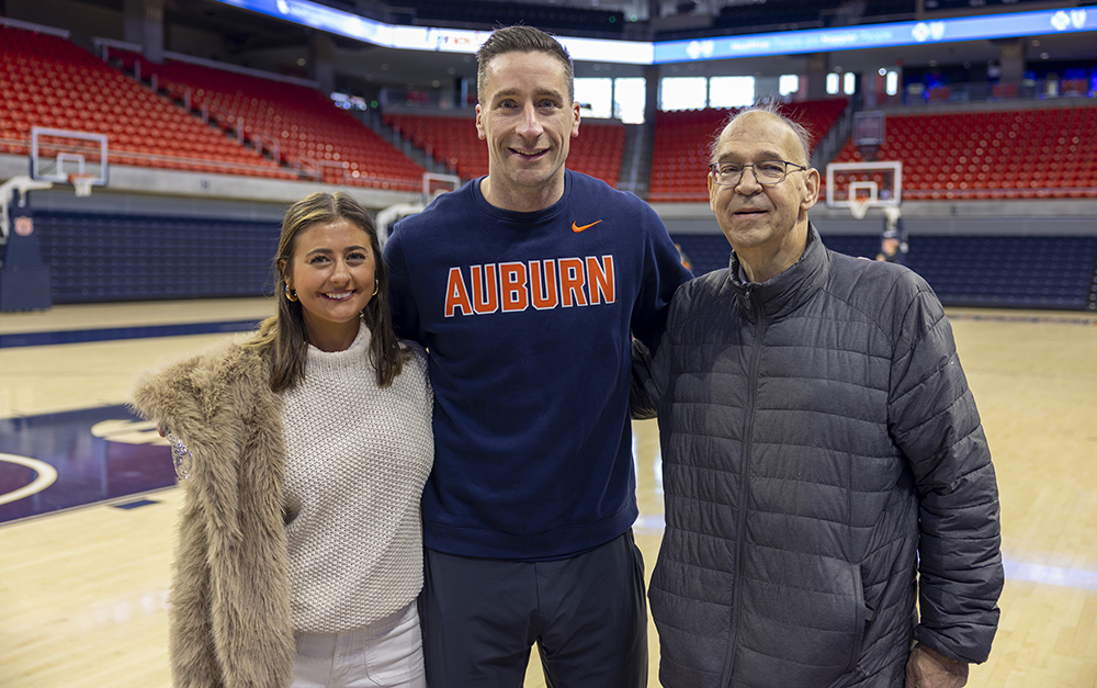 3 people standing on basketball court