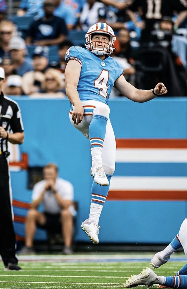 Punter kicking football