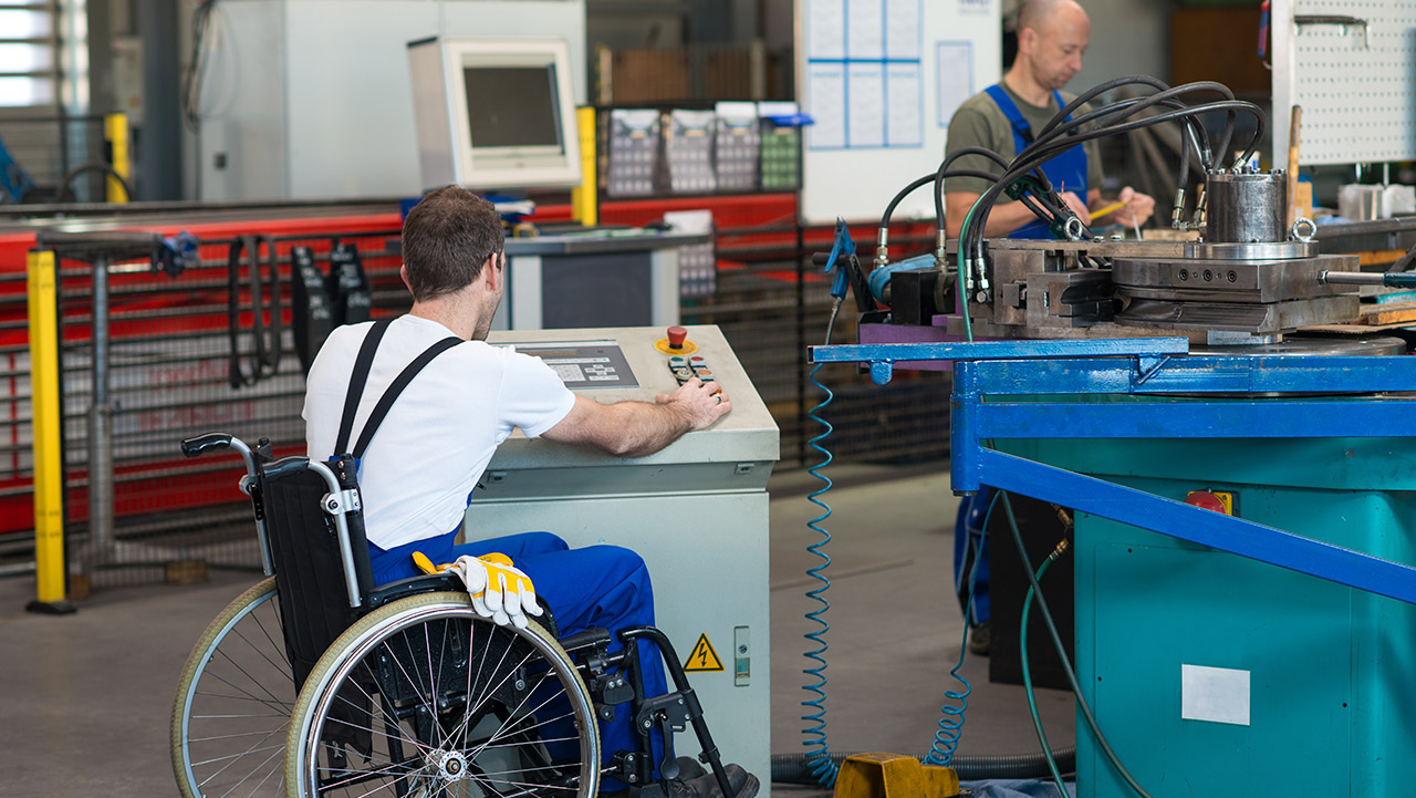Worker in wheelchair in manufacturing setting