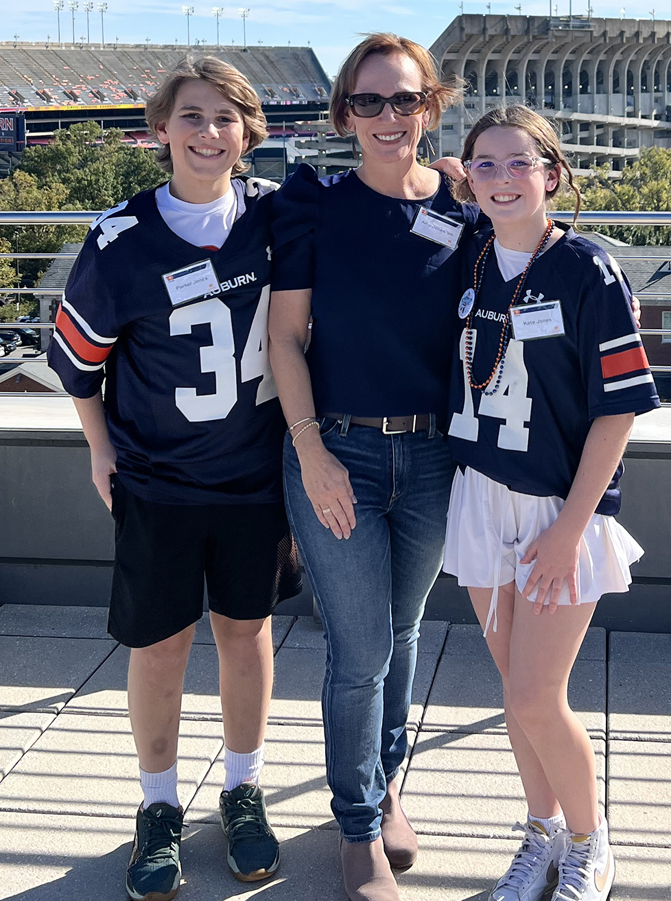 Alumna Amy Jones and 2 kids stading on HHH rooftop