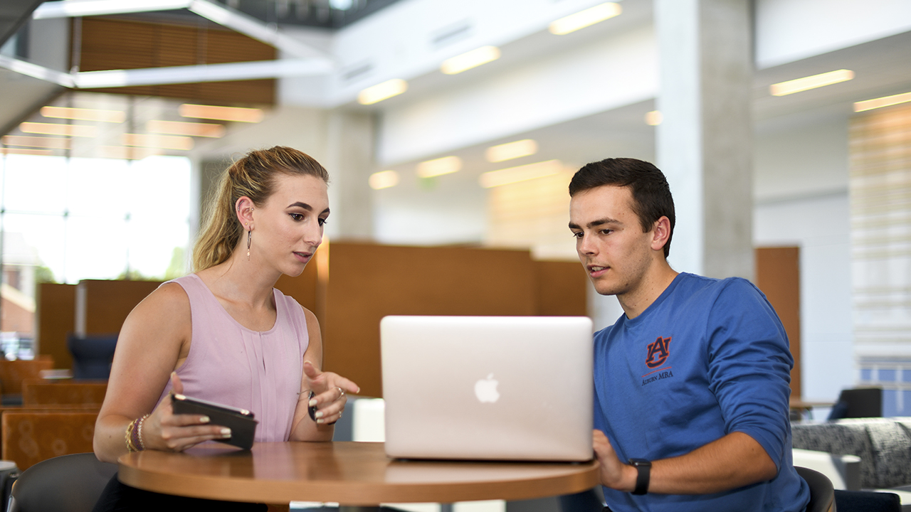 Woman and man student at table