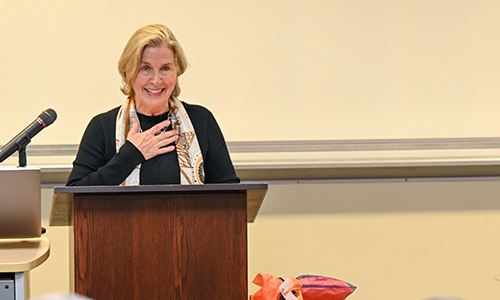 Catherine Sloss Jones speaking at a podium during CityBuilder lecture.