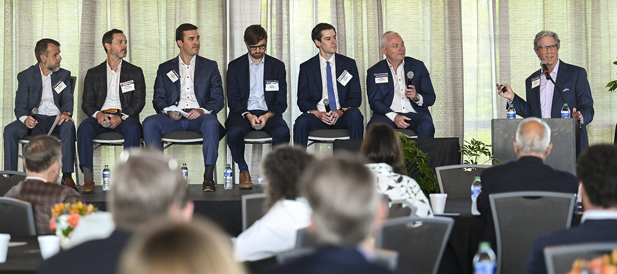Panel speakers seated in front of audience