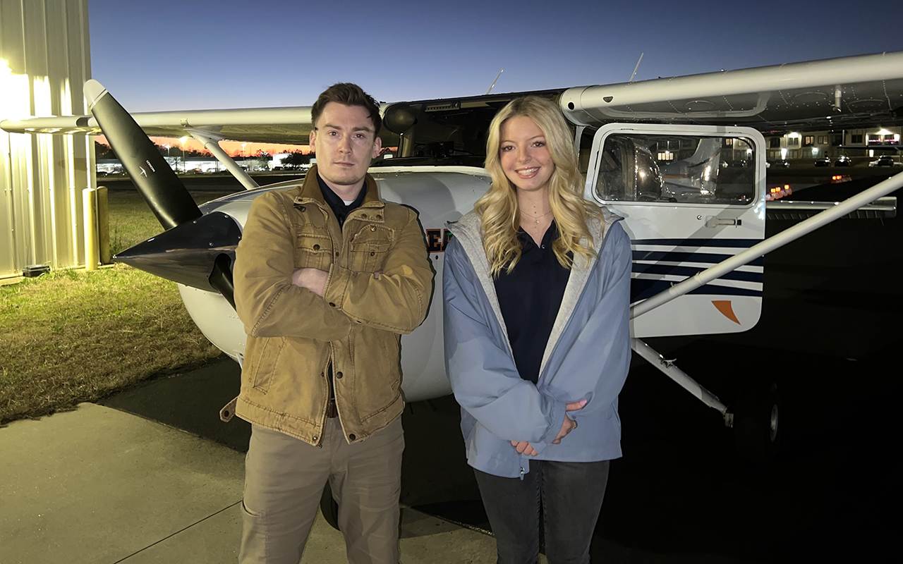 Ethan Franz Ethan Franz flight instructor with student standing in front of plane