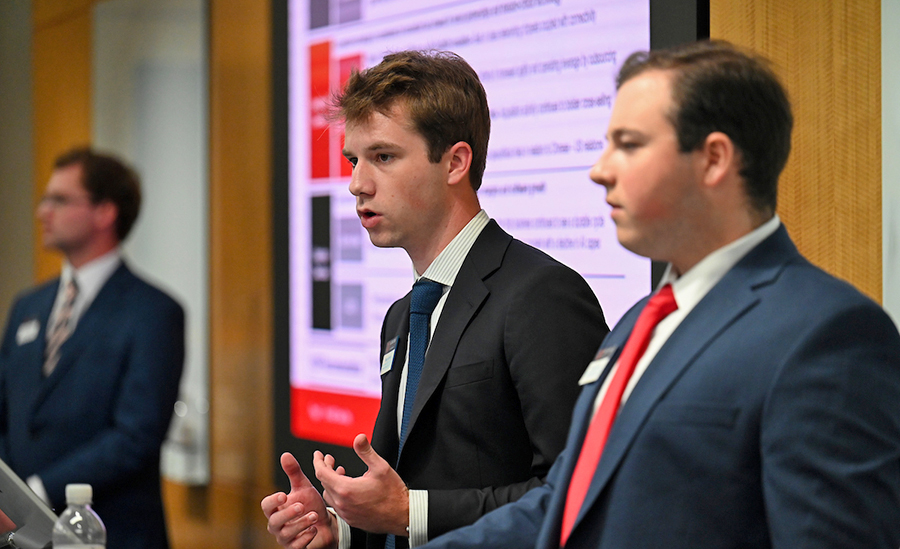 2 male students speaking to audience