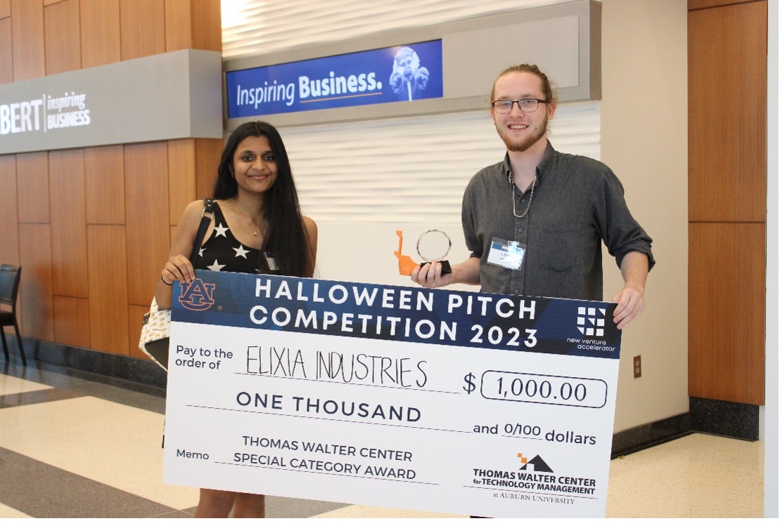 Elixa Industries students holding mock check