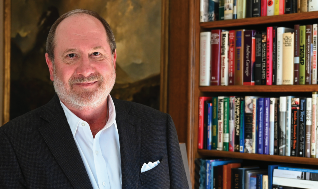 Raymond J. Harbert in his library