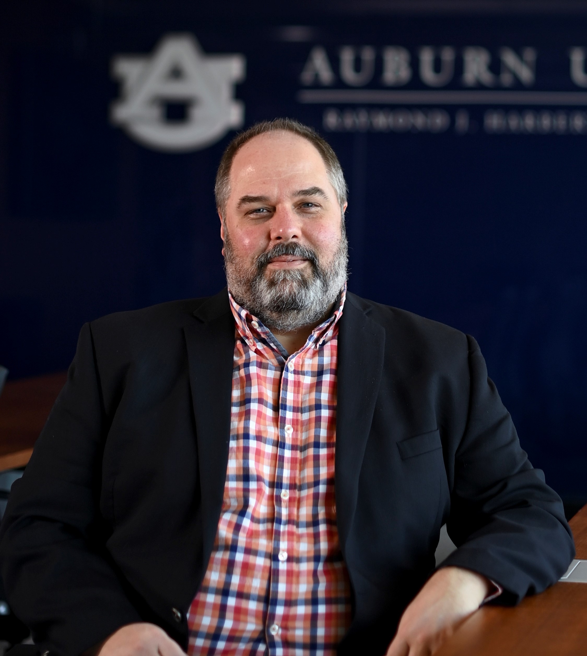 Justin Benefield seated at desk