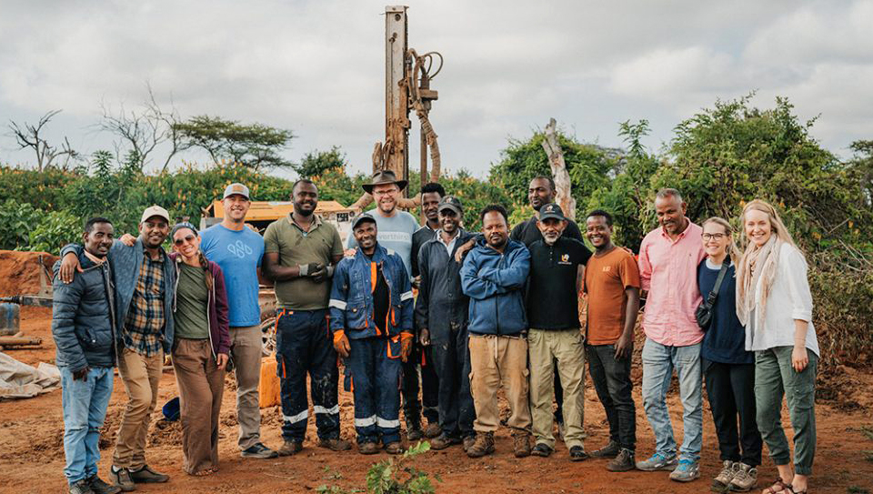 water drilling project neverthirst People standing near well drilling