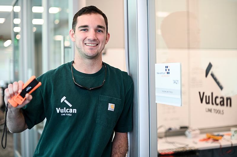 Vulcan Line Tools Man holding tool leaning on doorway