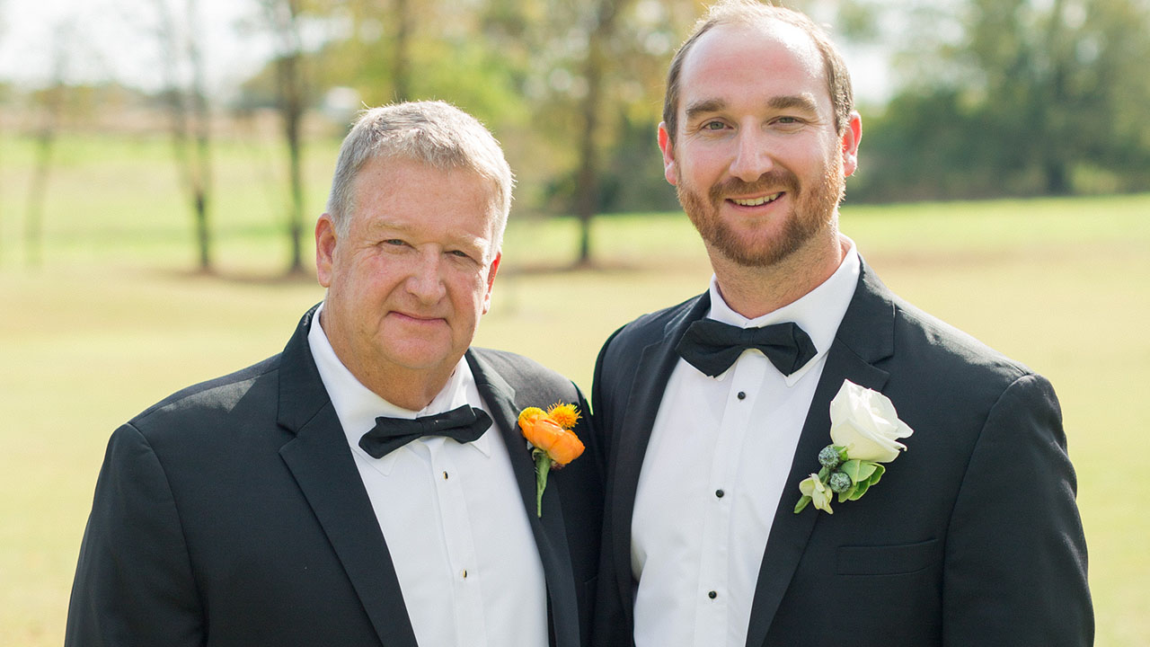 Ted Crane Jr and grandson standing together