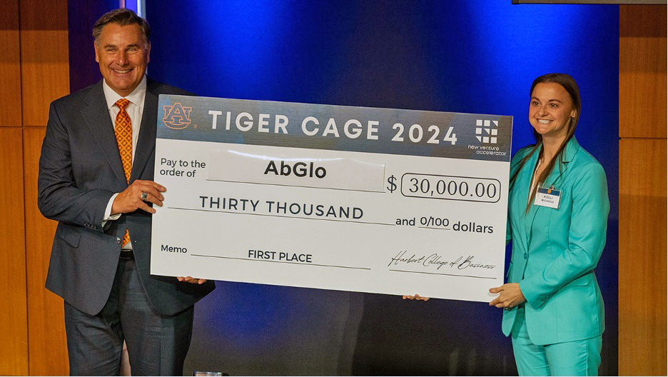 Tiger Cage winner holding check with founder