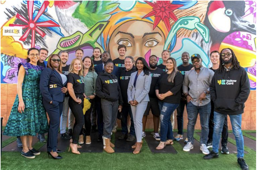 Group of people in front of mural