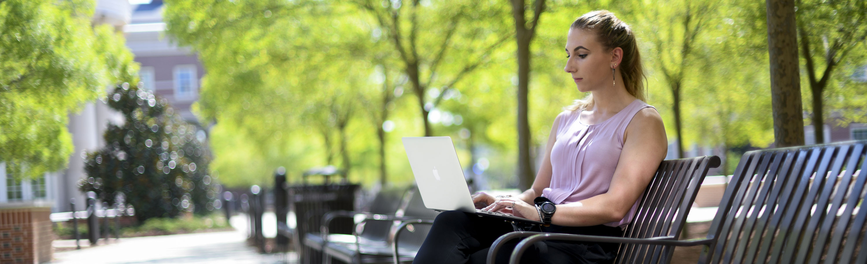 Student on a laptop in Horton-Hardgrave Hall atrium.