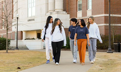 Fall 2022 Social Media Ambassadors walking in front of Lowder Hall