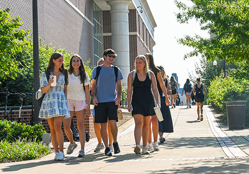 Students walking in a group through campus